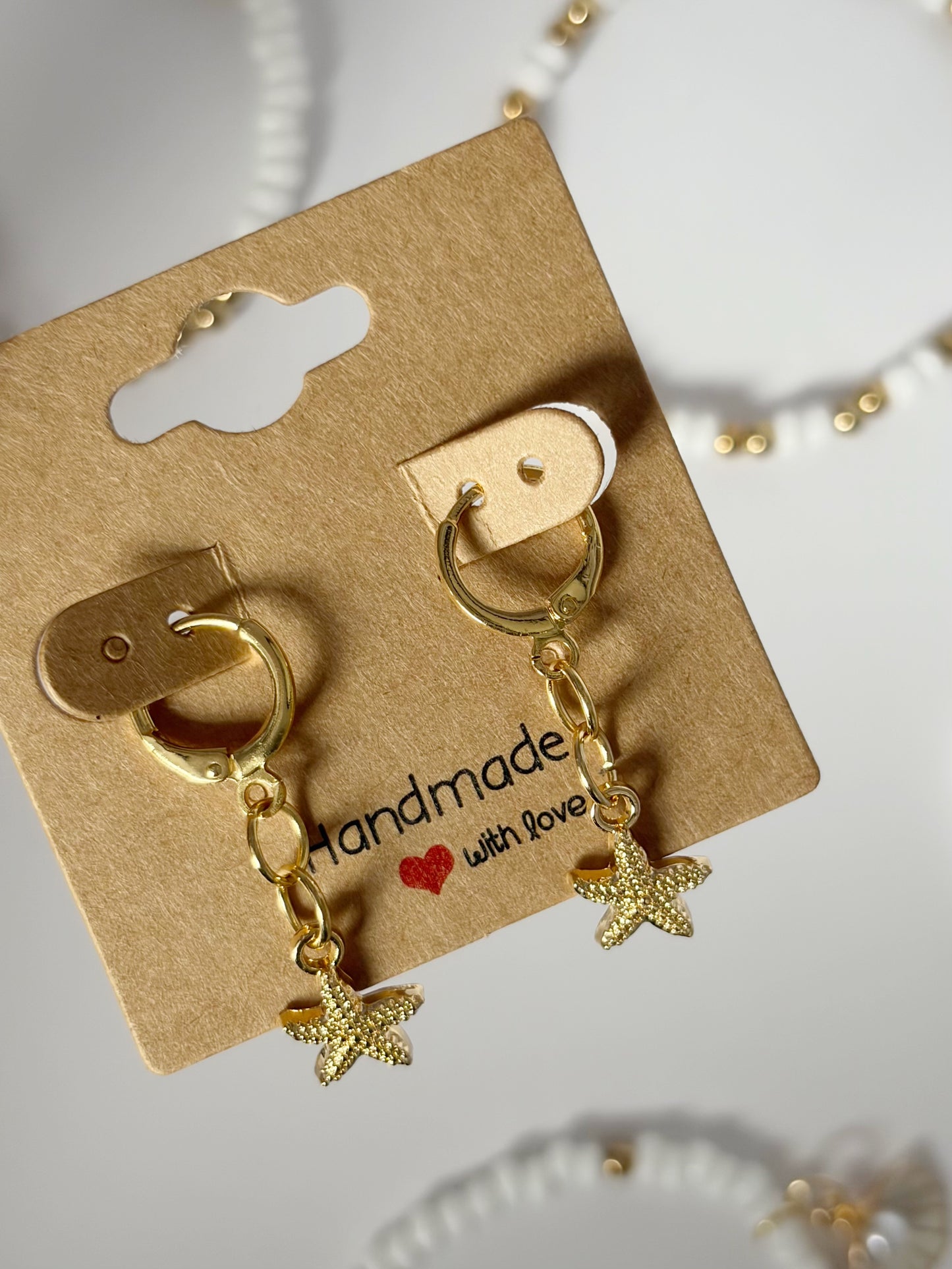 Small Gold Starfish Earrings On An 18K Gold Hoop